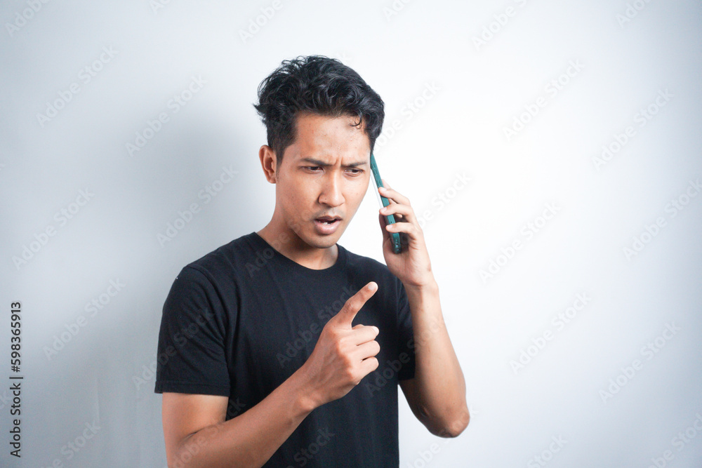 Young Asian Man wearing black tshirt very angry talk on phone Young Asian Man wearing black tshirt very angry talk on phone