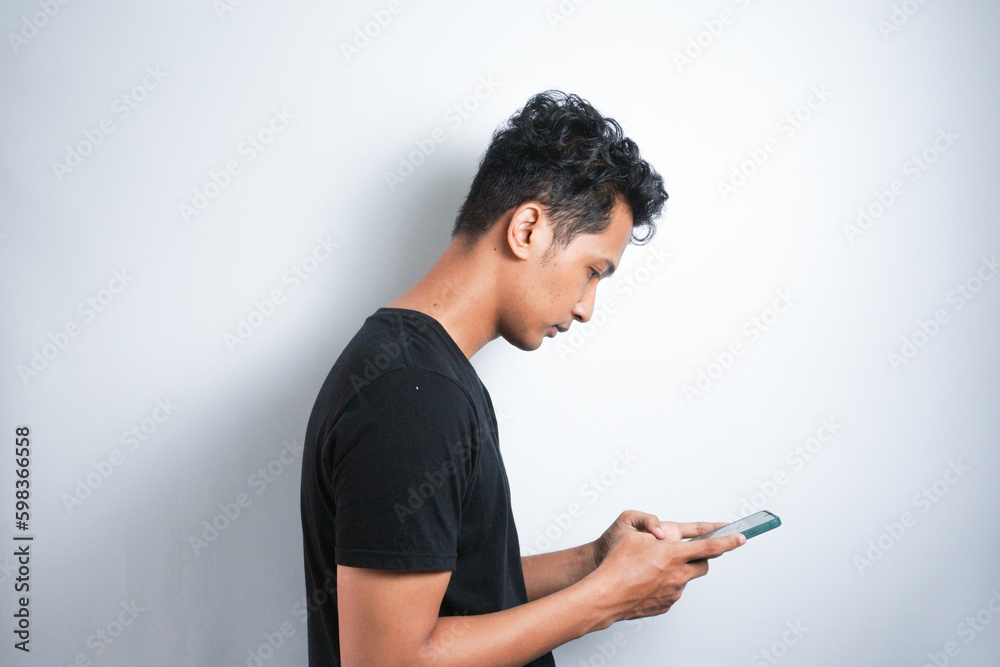 Asian man seriously concentrated on smartphone isolated on white background. Asian man seriously concentrated on smartphone isolated on white background.