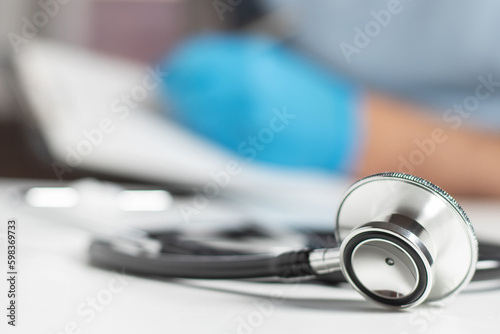 Stethoscope on background doctor and pacient blank in clinic photo