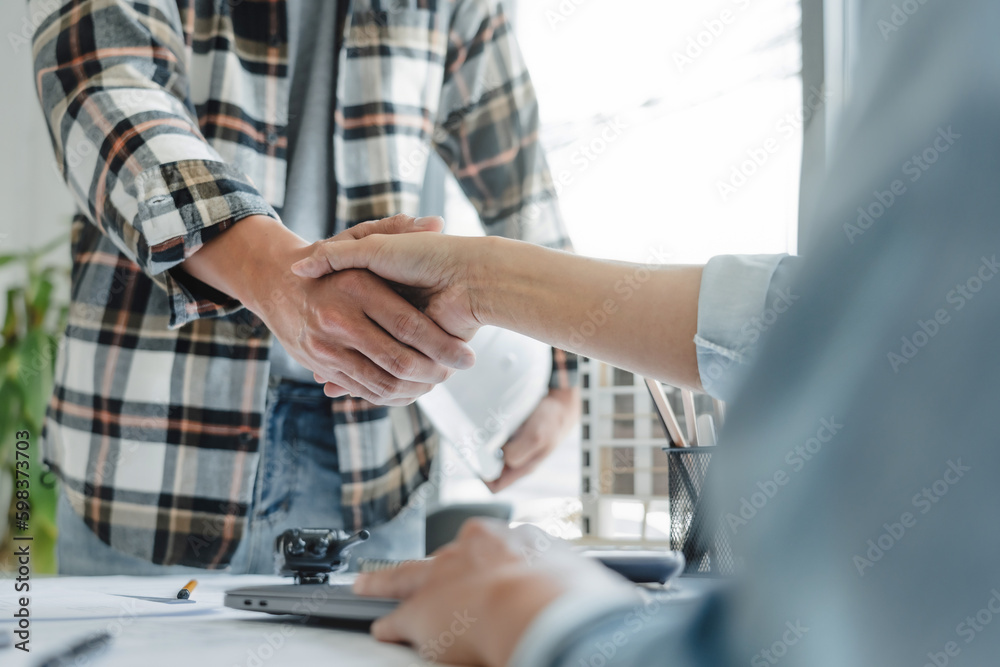 Interior architect shaking hand successful brainstorming on plan.. Interior architect shaking hand successful brainstorming on plan..