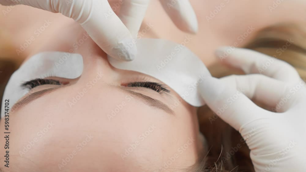 Client is relaxed and comfortable during the gentle process of eyelash extension. Beautiful woman at a reception at a beautician in a beauty salon. Relaxation and rest during the Generative AI Client is relaxed and comfortable during the gentle process of eyelash extension. Beautiful woman at a reception at a beautician in a beauty salon. Relaxation and rest during the Generative AI