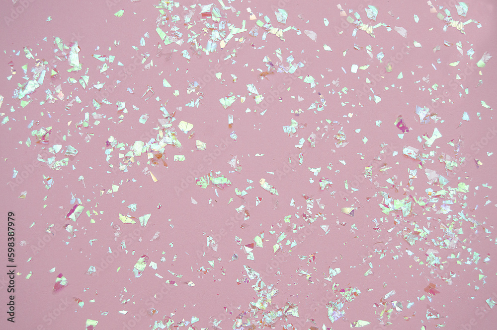 Pink background with sequins. Mica on a pink background. Texture. Space for text.