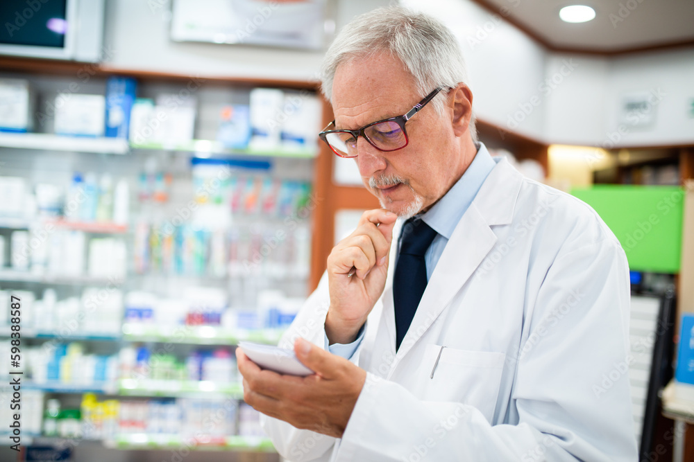 Pharmacist searching for a medicine while reading a prescription