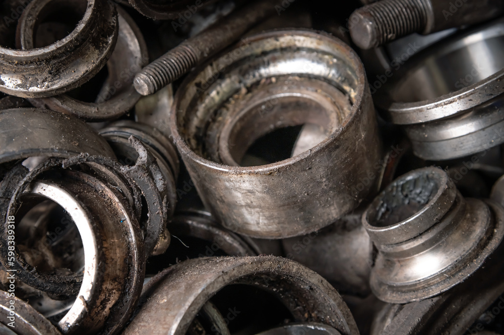 Close-up in selective focus Old pieces of automotive bearings. Metal waste from the automotive industry Close-up in selective focus Old pieces of automotive bearings. Metal waste from the automotive industry