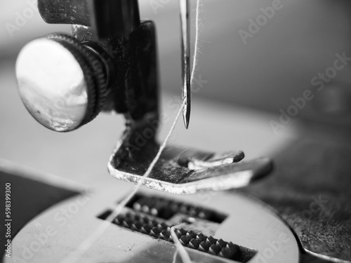 Fotografia, Obraz Macro of a threaded needle of a vintage sewing machine in black and white