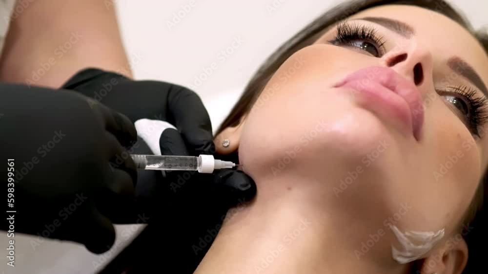 Filler injection of hyaluronic acid. Contour plastic for correcting the volume and shape of the nose, chin, cheekbones, temples. Cosmetic rejuvenating facial treatment in medical clinic Filler injection of hyaluronic acid. Contour plastic for correcting the volume and shape of the nose, chin, cheekbones, temples. Cosmetic rejuvenating facial treatment in medical clinic