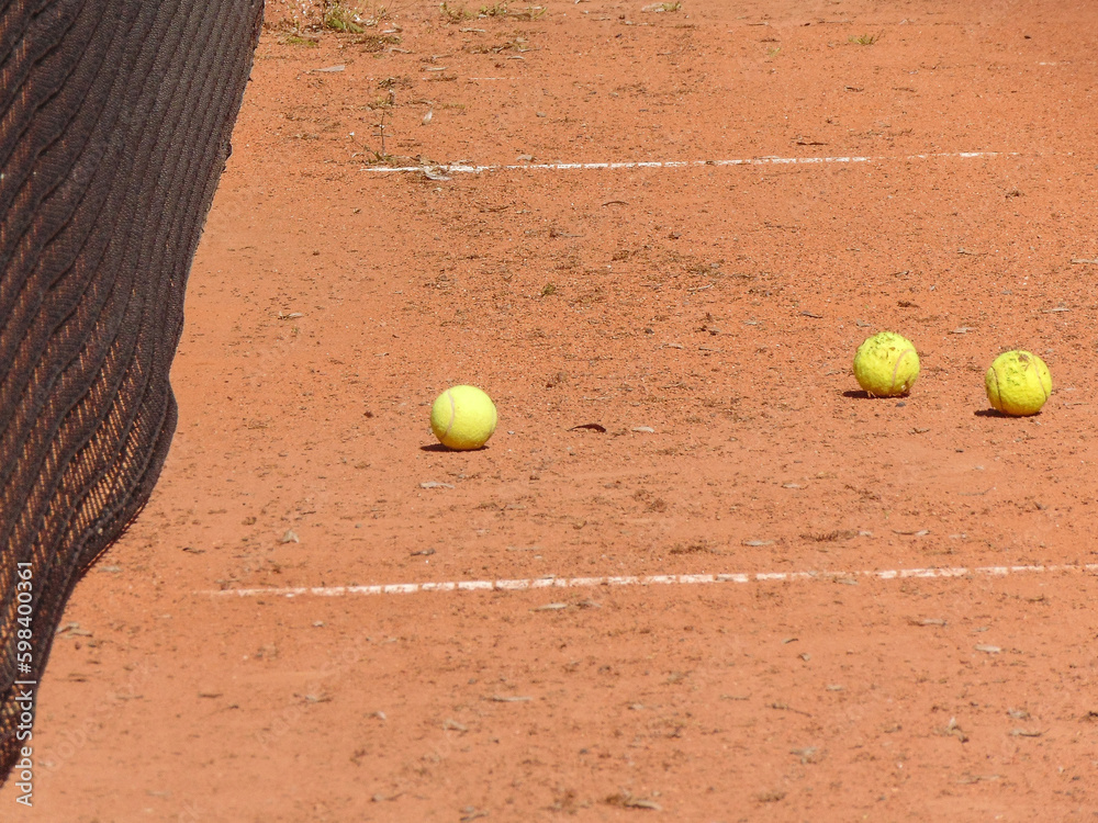 tennis balls on an amateur tennis court