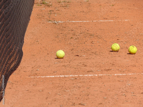 tennis balls on an amateur tennis court © Herman Vlad