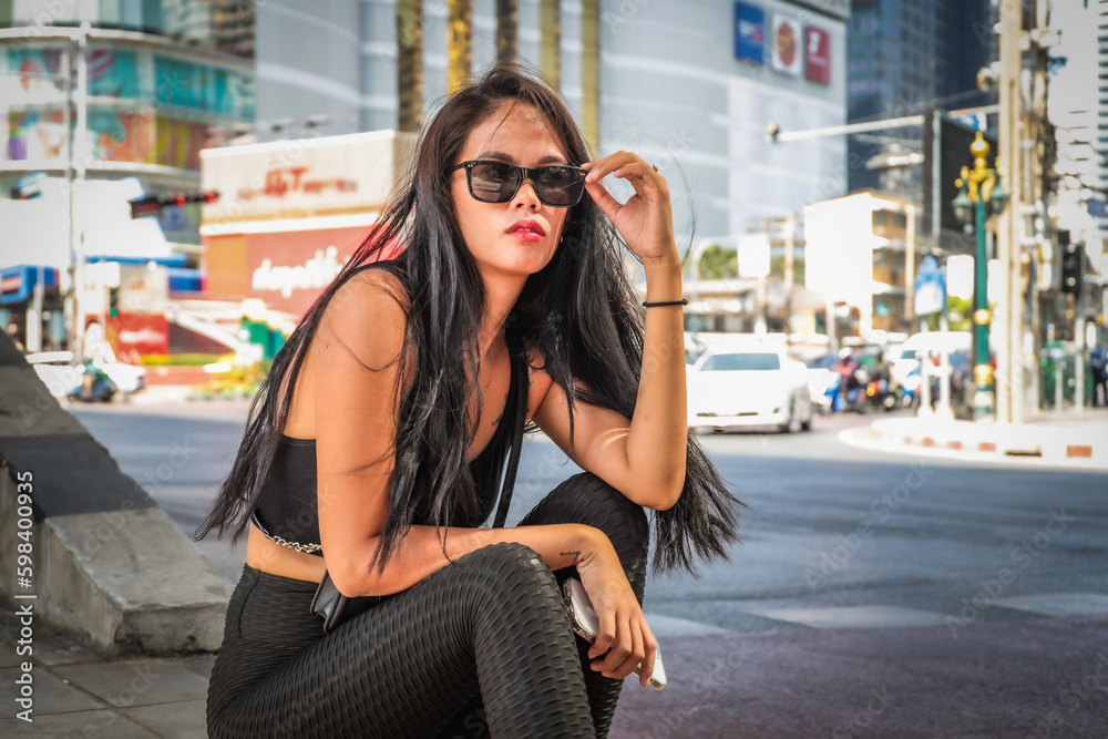 brunette in sunglasses sitting on the street brunette in sunglasses sitting on the street
