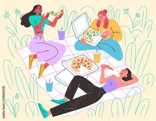 Girls in meadow on blanket eating pizza. Picnic, relaxing in nature