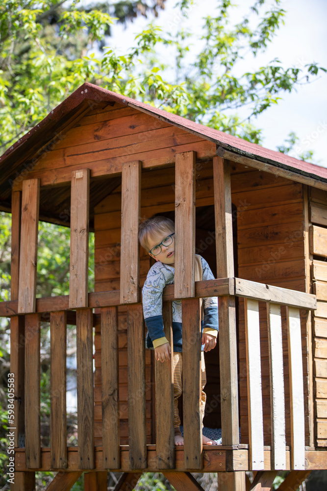 Cute little kid playing in a tree house Cute little kid playing in a tree house