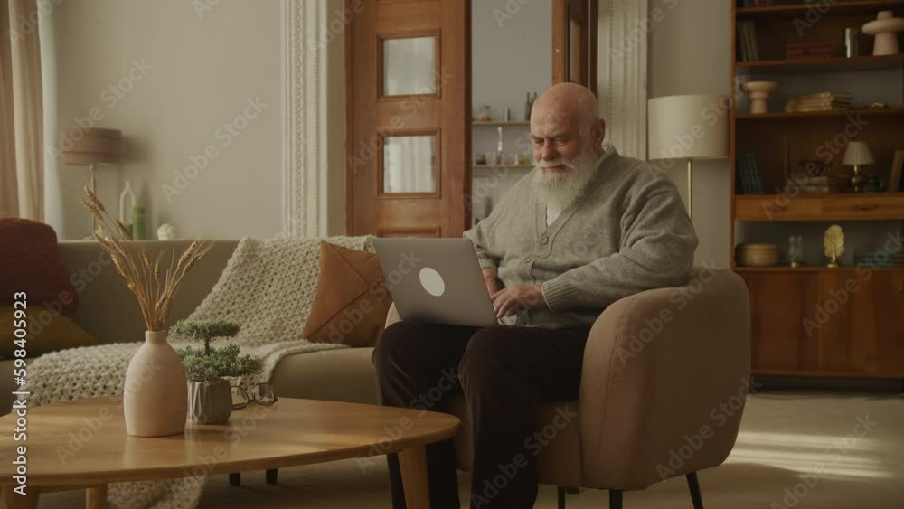 Old Man Browsing on Laptop, senior using computer Old Man Browsing on Laptop, senior using computer