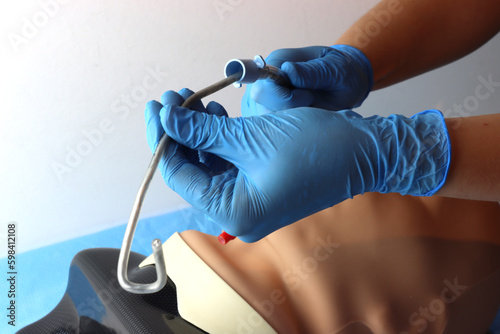 Endotracheal tube beeing inserted in a simulated patient with stylet support and photo showing the end of intubation with endotracheal tube stylet taking off 