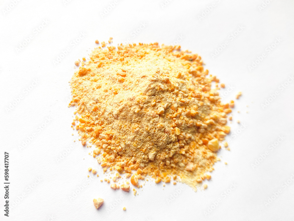 Crushed powder of split peas or field pea isolated on white background.Top view of crushed lentil,yellow split pea.Powdered pulses are used in a variety of cuisines.