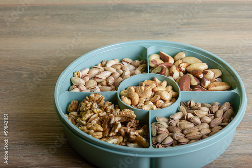 Mix of nuts in a container on a wooden table