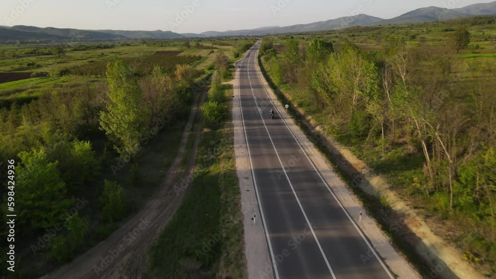 Motorcycle ride and car drive on the open road in sunny day in spring Motorcycle ride and car drive on the open road in sunny day in spring