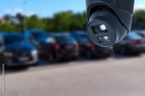 Closeup outdoor CCTV camera at a car parking lot. © Oleksandr