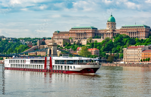 Cruise ship on Danube river with Royal palace at background, Budapest, Hungary