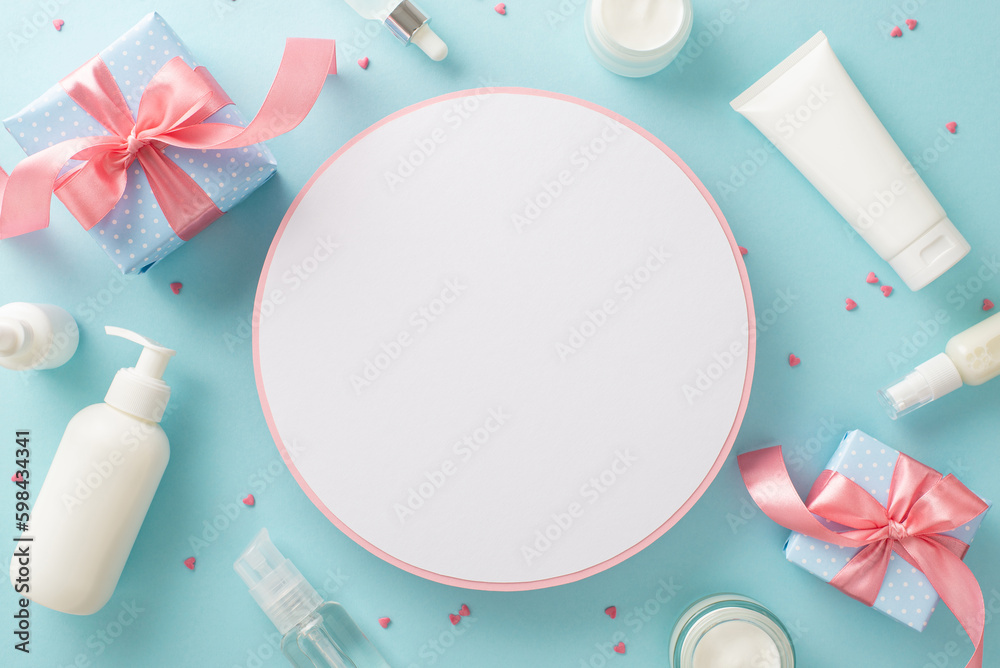 Pure flower beauty concept. Top view flat lay of pump bottle, pipette, cream bottles and tubes with flowers on pastel blue background with empty circle for text or branding