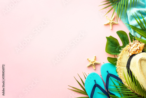 Summer flat lay background. Palm leaves, sea shells and summer cloth on pink background.