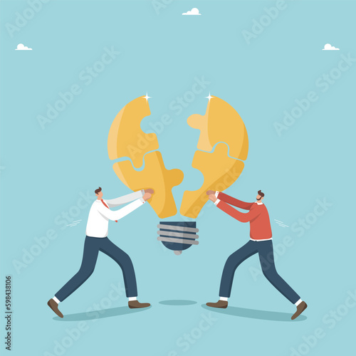 Collaboration and partnership in achieving common goals, teamwork to create innovative ideas for business, brainstorming to create development strategy, two men put together light bulb halves puzzles.