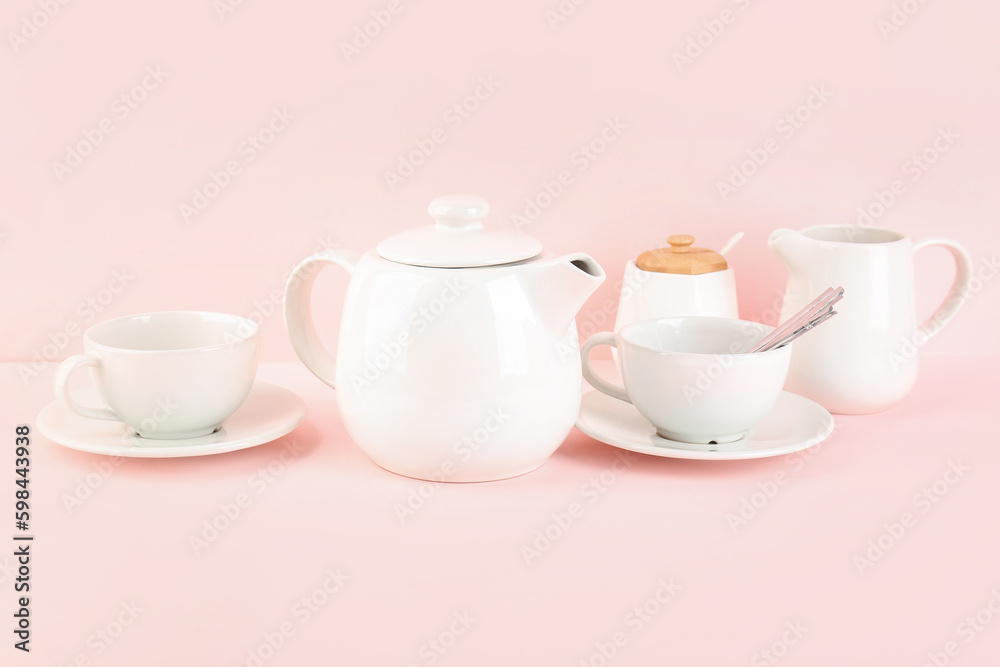 Stylish tea set on pink background