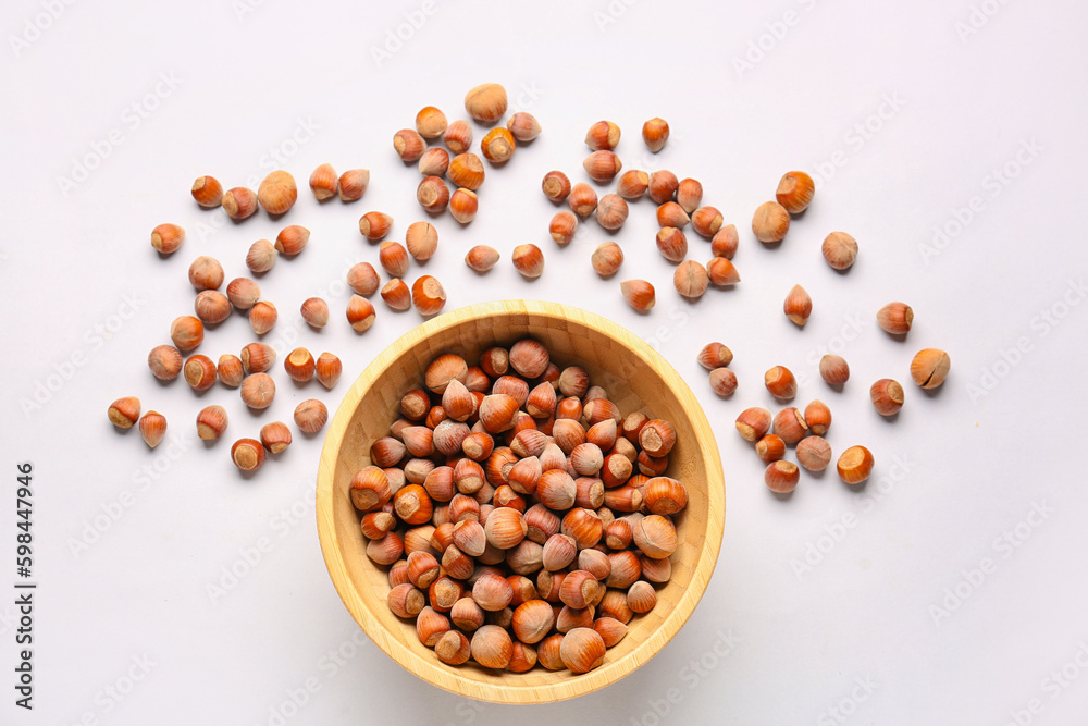 Bowl with shelled hazelnuts on light background Bowl with shelled hazelnuts on light background