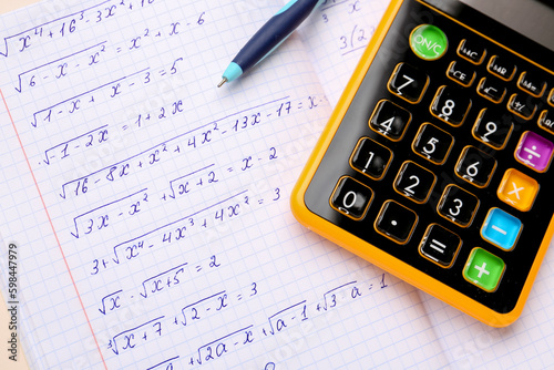 Cuadro en lienzo Copybook with maths formulas, calculator and pen, closeup