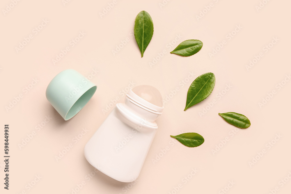 Deodorant with leaves on beige background