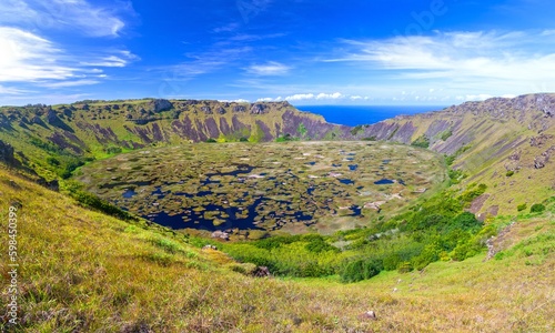 Rano Kau Extinct Volcano Crater Rim Panoramic Landscape with Green Wetland and Distant Pacific Ocean Horizon. Unesco World Heritage Site, Easter Island Rapa Nui, Chile photo