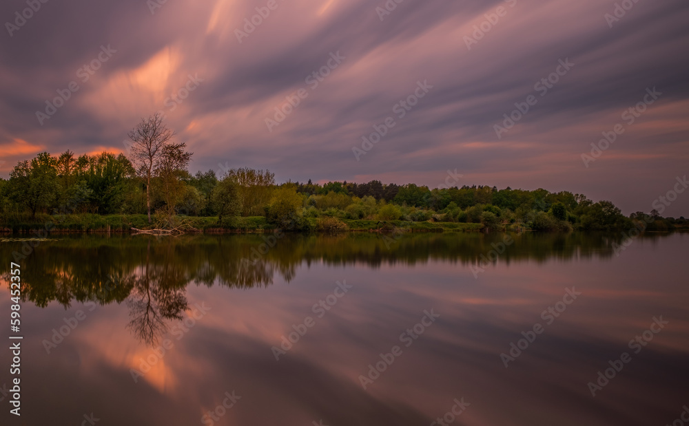 Long exposure fantastic sunset view on Bartatov Bartativ, Morozy village region Lviv. Lake and forest. Lviv district, Ukraine. May 2020