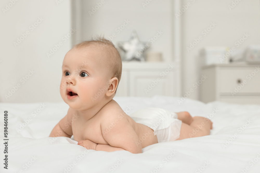 Cute baby lying on white bed at home, space for text Cute baby lying on white bed at home, space for text