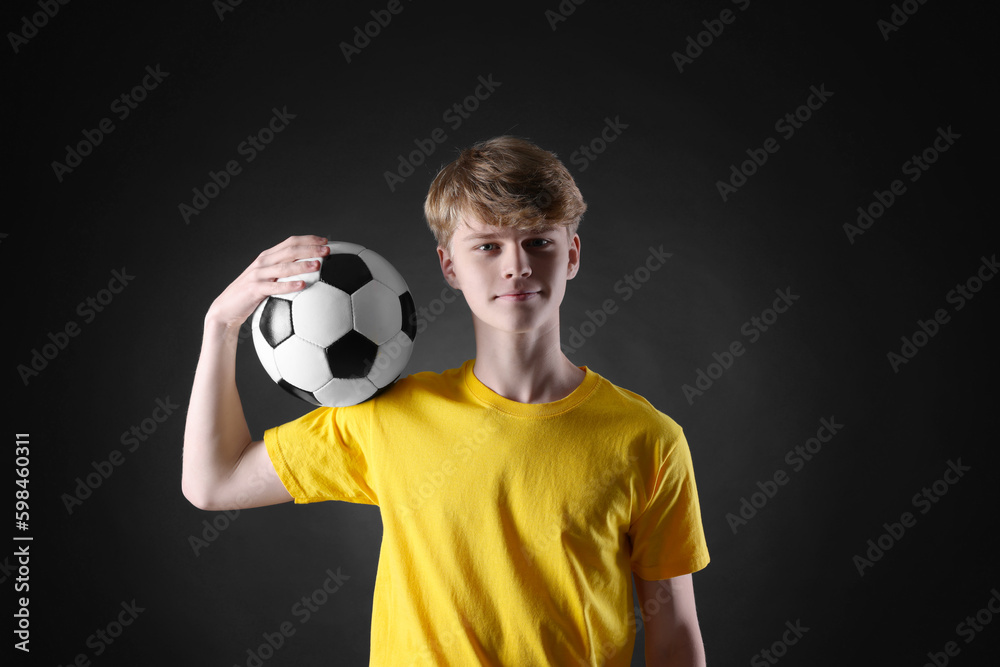 Teenage boy with soccer ball on black background Teenage boy with soccer ball on black background