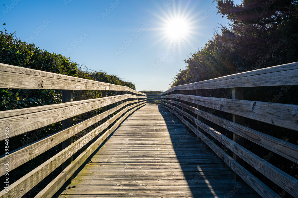 A Long Boardwalk Beach Access with the Sun Shining Bright on the Path to the Ocean