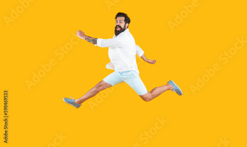 hurrying man isolated on yellow. hurrying man in studio. hurrying man on background.