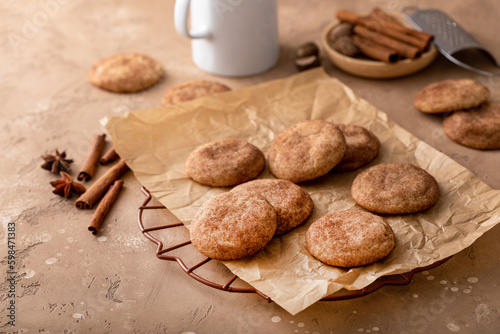 Cinnamon cookies on a parchment paper with milk