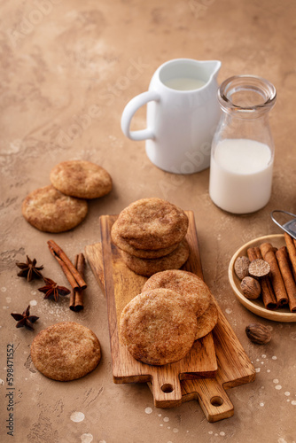 Cinnamon cookies on wooden board with milk