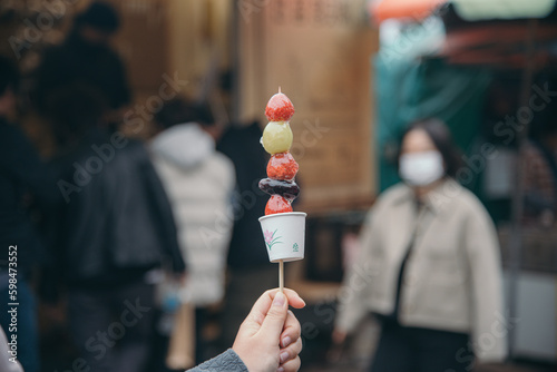 Candy fruit stick with blur market background 