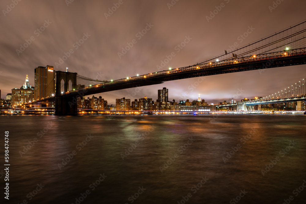View of Lower Manhattan, the World Trade One building and the surrounding Brooklyn Bridge, as seen from Brooklyn, near the D.U.M.B.O.