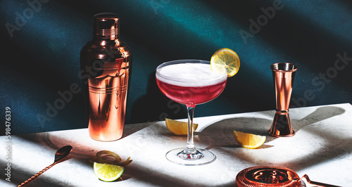 Canvas Print Pink lady classic cocktail drink with dry gin, grenadine syrup, lemon juice and egg white, dark green background, bright hard light, shadow pattern