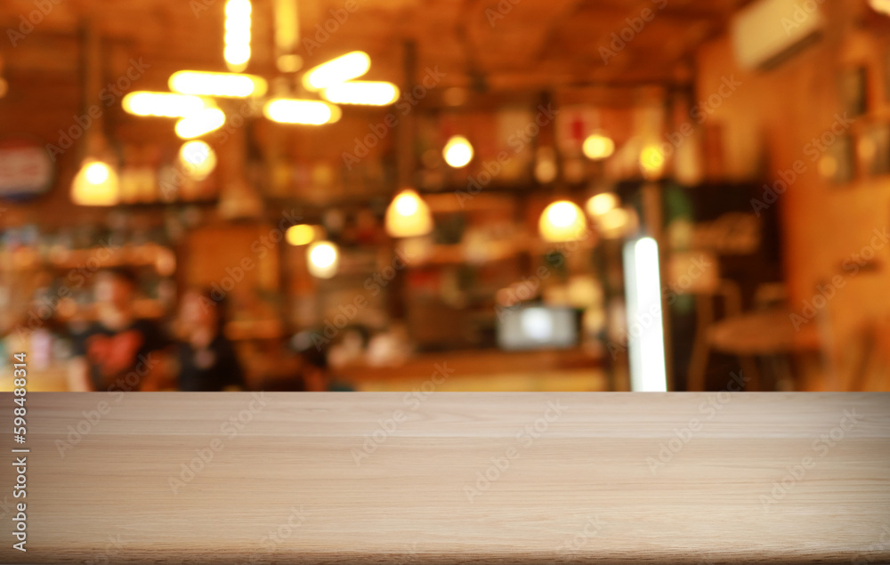 Empty wooden table in front of abstract blurred background of coffee shop . can be used for display or montage your products.Mock up for display of product Empty wooden table in front of abstract blurred background of coffee shop . can be used for display or montage your products.Mock up for display of product