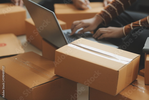 Business woman start up small business entrepreneur SME success .freelance woman working at home with Online Parcel delivery. SME and packaging deliveryconcept © Sirikarn Rinruesee