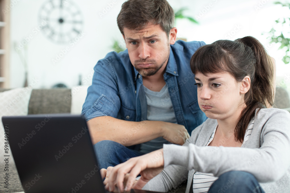 couple calculating their domestic budget with stressed and frustrated looks couple calculating their domestic budget with stressed and frustrated looks