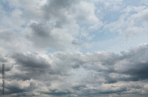 A stormy sky full of gray clouds . The sky before the rain.