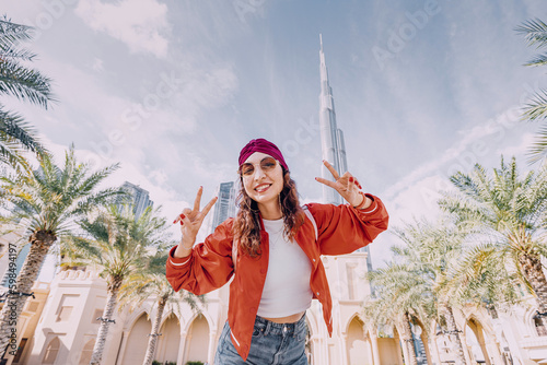 The girl's face is beaming with pure joy as she takes in the stunning view of Dubai. The skyscrapers and cityscape surrounding her seem to fill her with a sense of awe photo