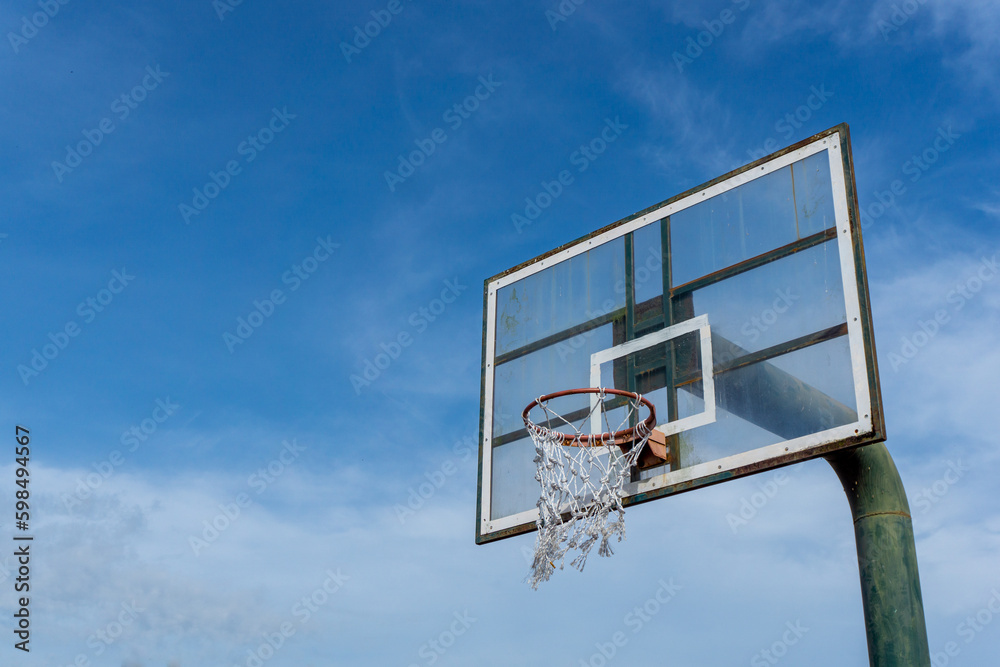 Low angle view of basketball ring on sky background. Outdoor basketball hoop.