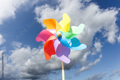colorful pin wheel or wind wheel with cloudy sky