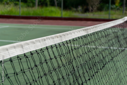 Tennis net blown by the wind. Close up of tennis court net © fery