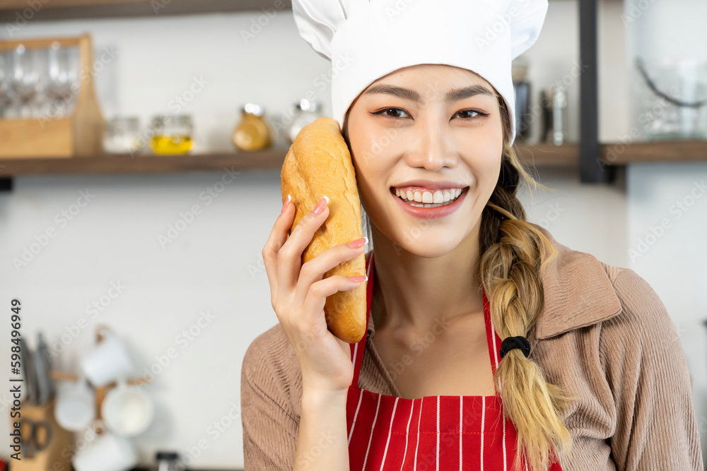 Beautiful asian young female chef preparing healthy food in kitchen