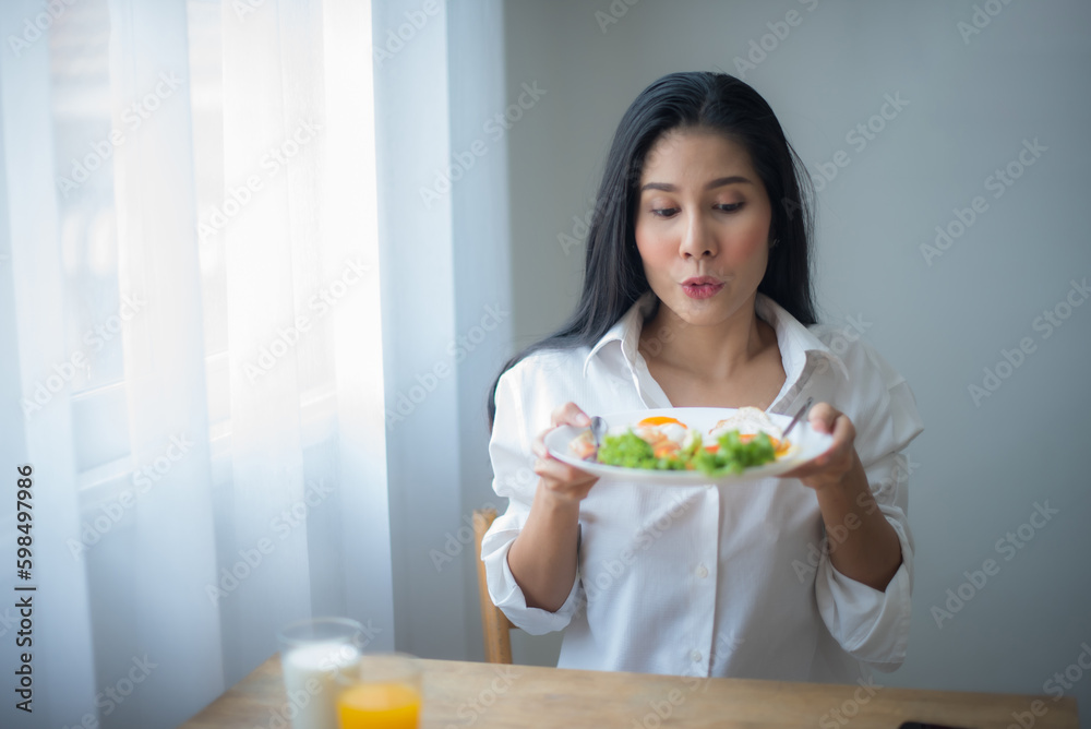 Beautiful asian woman is excited about healthy vegetables on her plate. Beautiful asian woman is excited about healthy vegetables on her plate.
